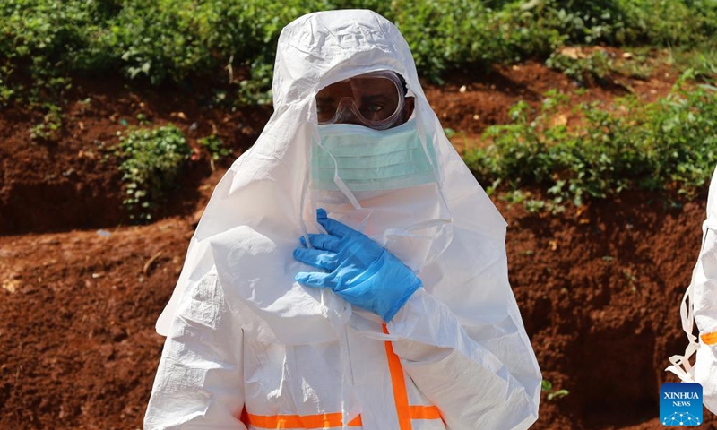 A medical worker puts on protective suits before the burial of an Ebola victim in Mongbwalu, Ituri province, eastern Democratic Republic of the Congo (DRC), May 24, 2026. World Health Organization (WHO) Director-General Tedros Adhanom Ghebreyesus said on Sunday that as the Democratic Republic of the Congo (DRC) scales up surveillance in its Ebola response, more than 900 suspected cases have been identified so far, including 101 confirmed cases. (Photo: Xinhua)