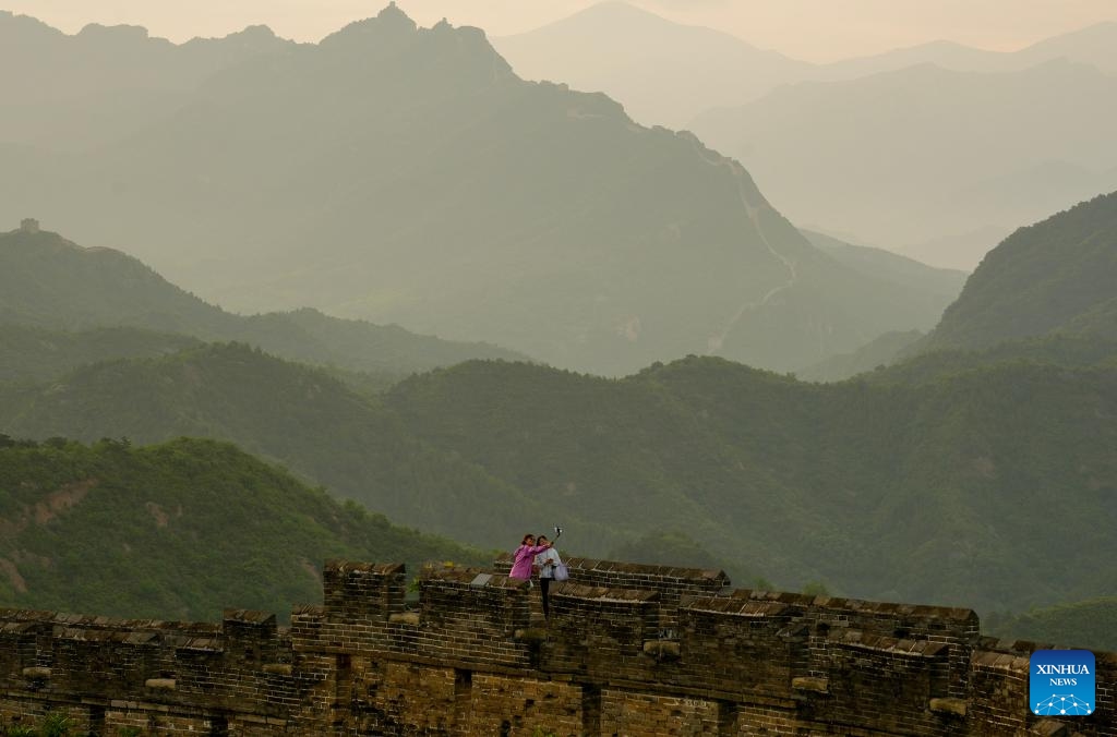 Visitors take selfies at the Jinshanling section of the Great Wall in Luanping County, Chengde City of north China's Hebei Province, May 26, 2026. (Photo: Xinhua)