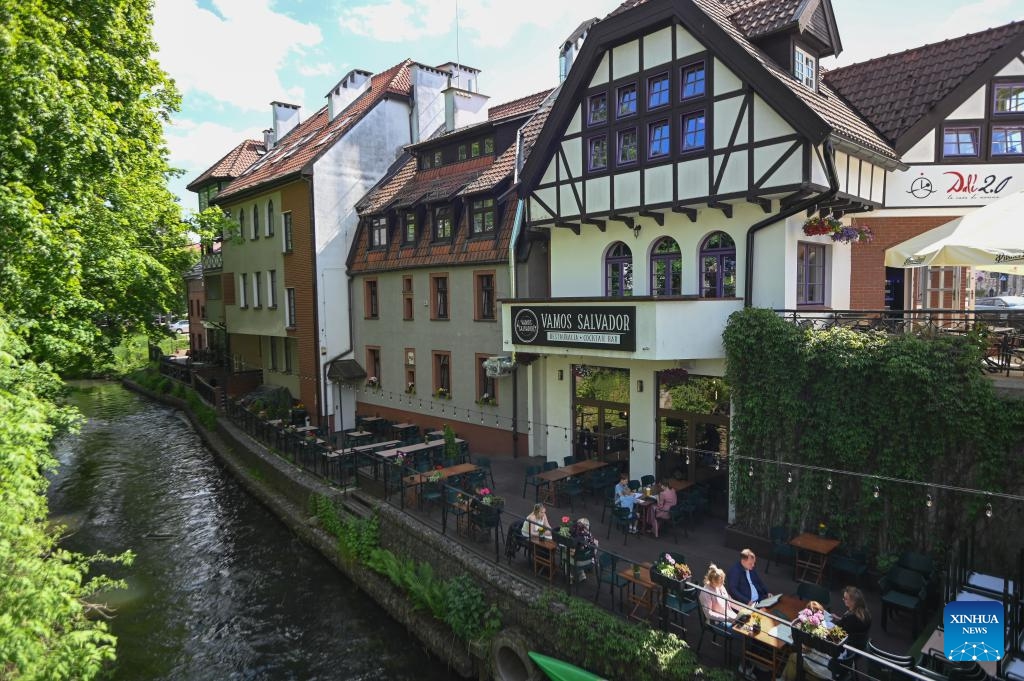 Buildings and restaurants along the Lyna River are seen in Olsztyn, Poland, May 26, 2026. The city is known for its lakes and natural scenery. (Photo: Xinhua)