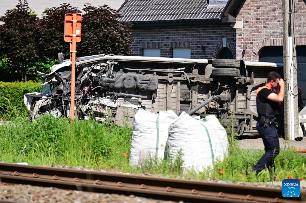A man walks past the scene of a school bus and train collision accident in Buggenhout, East Flanders, Belgium, May 26, 2026. Four people were killed on Tuesday morning after a school bus rammed into a train at a crossing in the city of Buggenhout, the East Flanders province of Belgium, local media reported. (Photo: Xinhua)