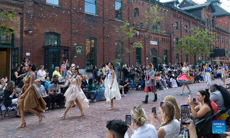 Models present creations on a pedestrian street during the Fashion Art Toronto's Fashion Week Spring/Summer 2026 in Toronto, Canada, on May 26, 2026. (Photo: Xinhua)