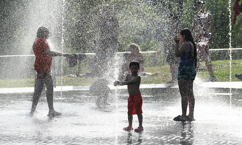 People cool off in the water amid heat wave at a park in Madrid, Spain, May 24, 2026. (Photo: Xinhua)
