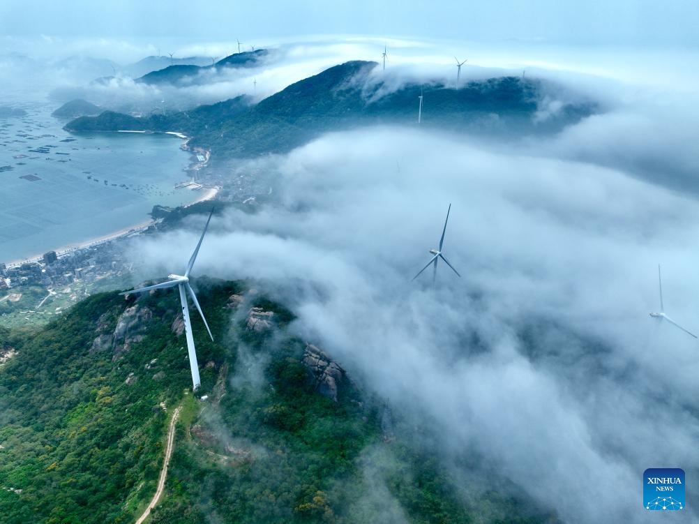 An aerial drone photo taken on May 27, 2026 shows a wind farm shrouded in fog in Lianjiang, southeast China's Fujian Province. (Xinhua/Jiang Kehong)