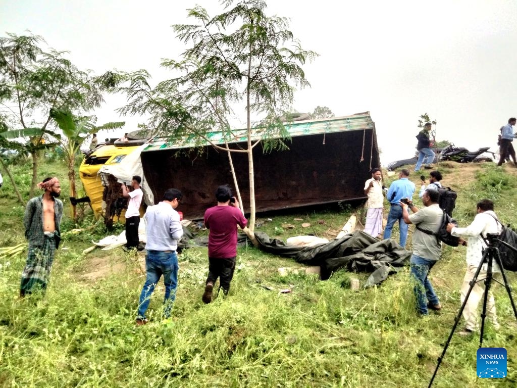 People gather at the site of a truck accident in Tangail district, Bangladesh, May 25, 2026. At least 15 people were killed, and six others injured early on Monday when a rod-laden truck overturned into a bridge-side ditch in Bangladesh's Tangail district, some 97 km away from the capital Dhaka. (Photo: Xinhua)