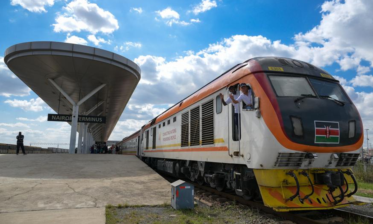 Train drivers Jiang Liping (R) and Bor wave aboard a train to Mombasa at Nairobi Terminus of the China-built Mombasa-Nairobi Standard Gauge Railway (SGR) in Nairobi, Kenya, on May 31, 2025. Photo: Xinhua