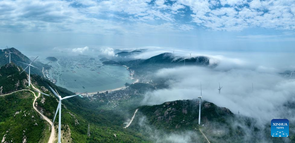 An aerial drone photo taken on May 27, 2026 shows a wind farm shrouded in fog in Lianjiang, southeast China's Fujian Province. (Xinhua/Jiang Kehong)