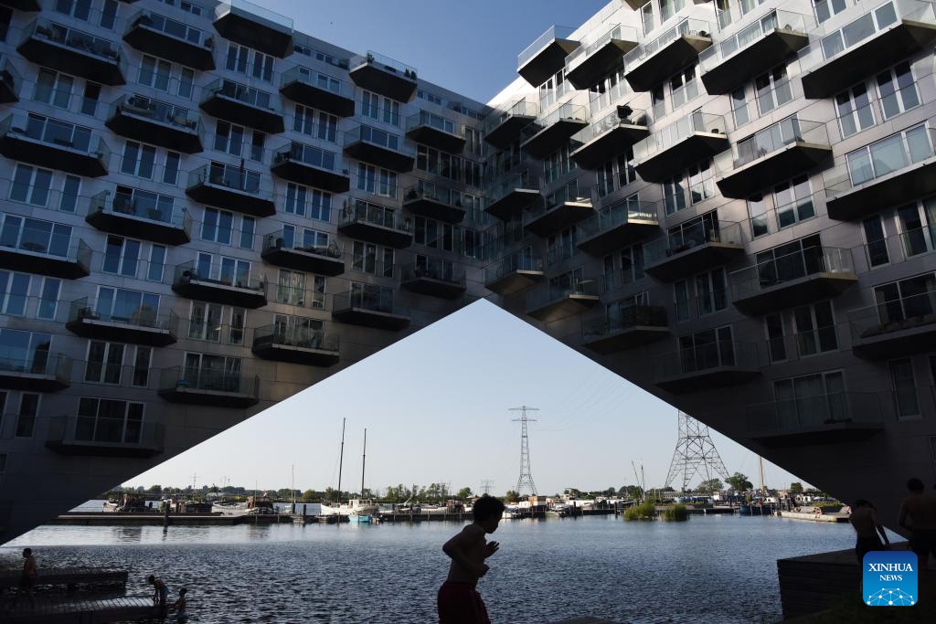 This photo taken on May 26, 2026 shows a view of Sluishuis in Amsterdam, the Netherlands. Sluishuis is a landmark residential building in Amsterdam. Completed in 2022, the building is known for its unique geometric design, with one corner rising upward to create a large opening over the water. (Photo: Xinhua)