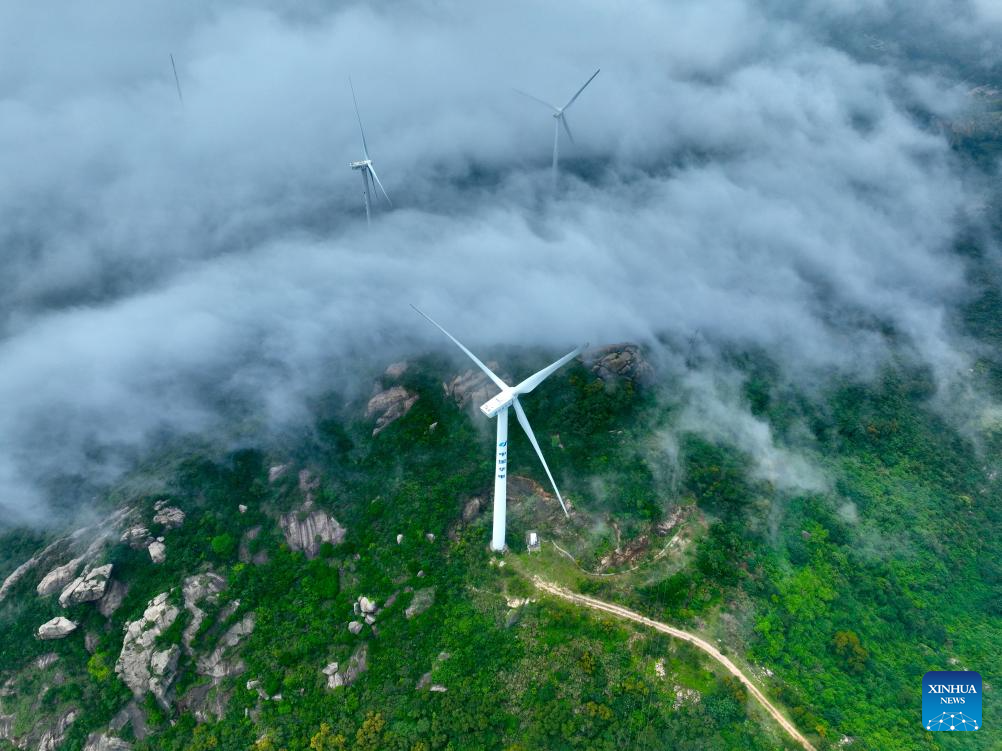An aerial drone photo taken on May 27, 2026 shows a wind farm shrouded in fog in Lianjiang, southeast China's Fujian Province. (Xinhua/Jiang Kehong)