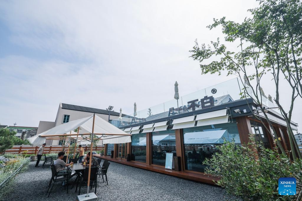 Tourists have a rest at the outdoor space of a restaurant in Huanlou Village, Huzhou City, east China's Zhejiang Province, May 27, 2026. Taking the youth entrepreneurship platform as a core link, Huanlou Village has developed a variety of cultural and tourism scenarios including tea culture experience spaces, outdoor camps, local specialty catering outlets, and parent-child interaction programs in recent years. (Photo: Xinhua)