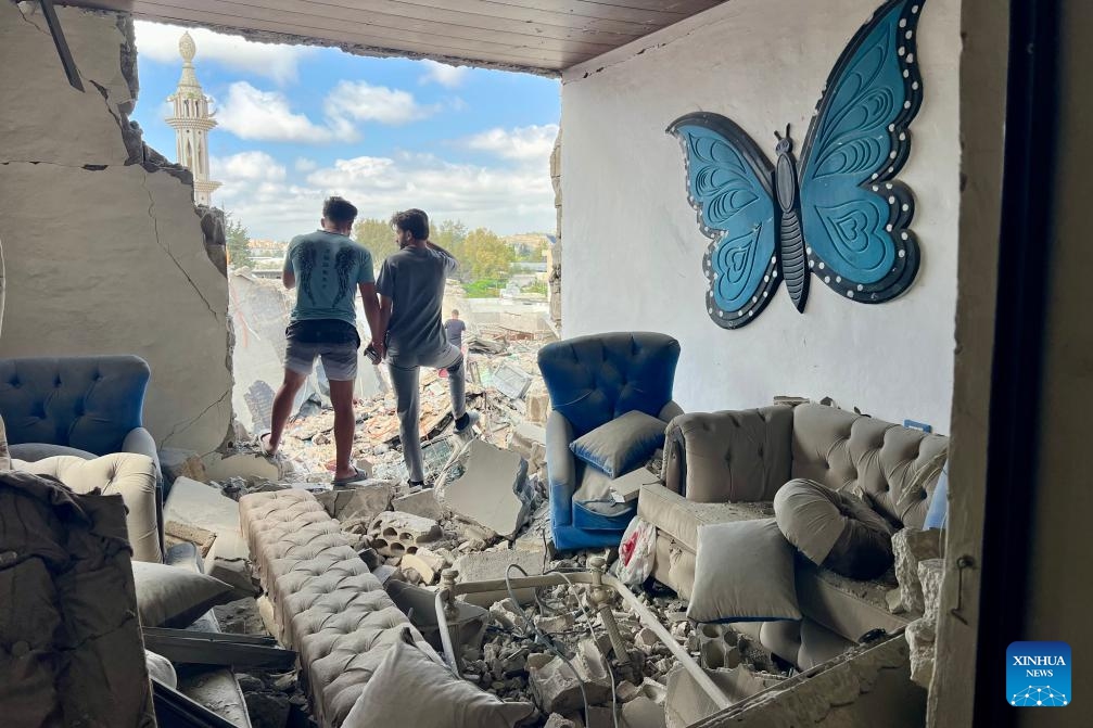 People stand among the debris of a house destroyed by an Israeli airstrike in Tyre, Lebanon, May 26, 2026. Israeli strikes on southern and eastern Lebanon killed at least 18 people and wounded more than 20 others on Tuesday, according to Lebanon's official sources, as Israel intensified its bombardment campaign across southern Lebanon. (Photo: Xinhua)