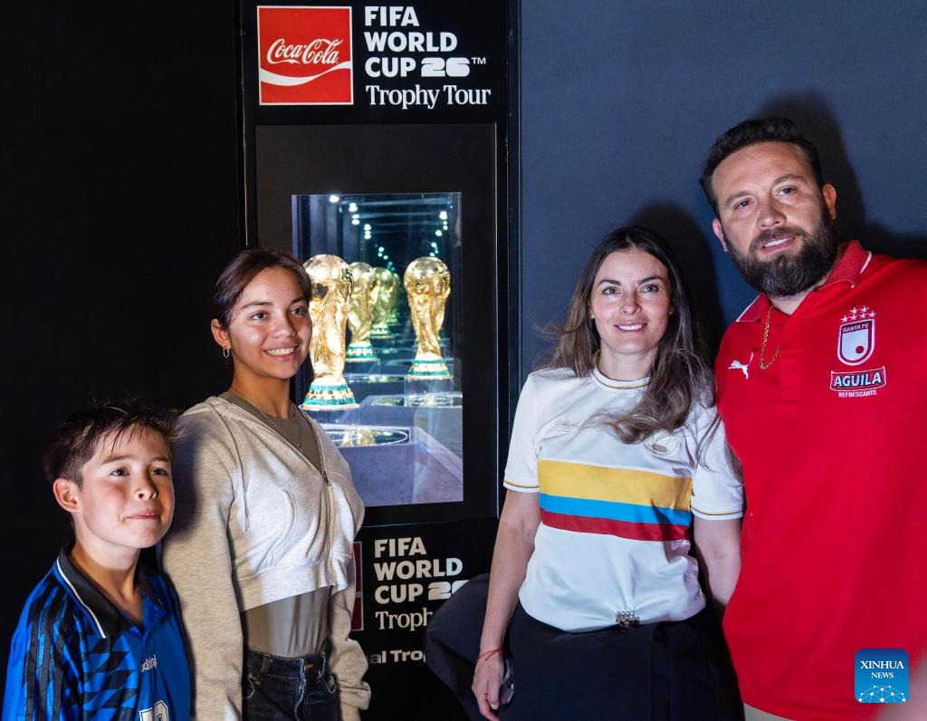 People pose for photos with the original FIFA World Cup Trophy during the Toronto stop of the FIFA World Cup Trophy Tour at Nathan Phillips Square in Toronto, Canada, on May 26, 2026. (Photo: Xinhua)