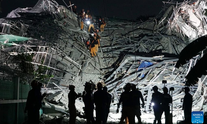 Rescuers search for survivors at the site of a collapsed building in Angeles City, Pampanga province, the Philippines, May 24, 2026. Four people were confirmed dead after a building collapsed before dawn Sunday in Angeles City in northern Philippines' Pampanga province, as search and rescue operations continue for 17 missing people, authorities said Monday. (Photo: Xinhua)