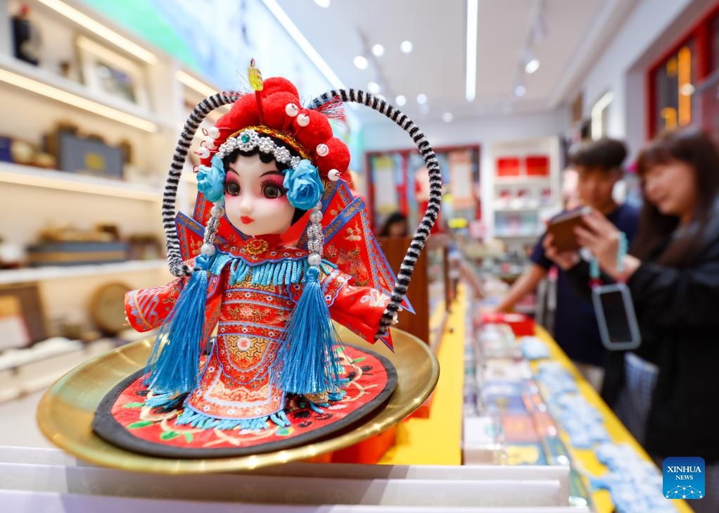 Tourists shop for cultural and creative products at a shop in a pedestrian street in Shijiazhuang, north China's Hebei Province, May 22, 2026. Shijiazhuang has been boosting its nighttime economy to unlock the local consumption potential. The city has integrated cross-sector resources in commerce, culture, tourism and sports to diversify nighttime consumption scenarios and improve service quality. (Photo: Xinhua)