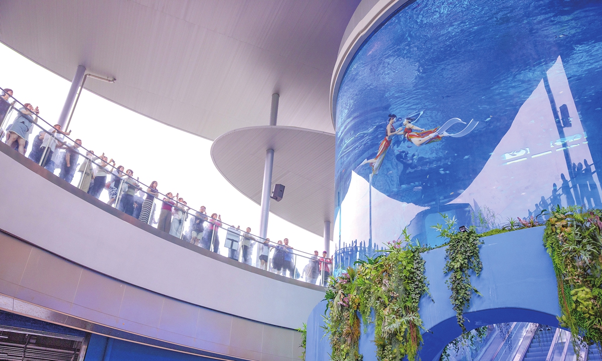 People watch underwater dancing performances by 