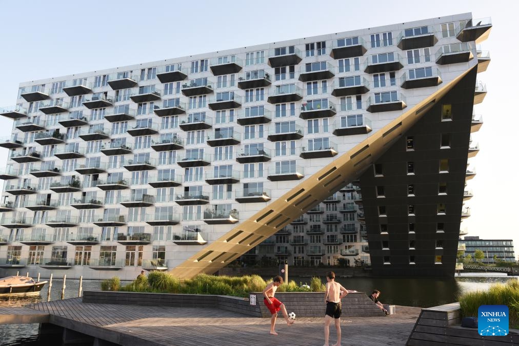 This photo taken on May 26, 2026 shows a view of Sluishuis in Amsterdam, the Netherlands. Sluishuis is a landmark residential building in Amsterdam. Completed in 2022, the building is known for its unique geometric design, with one corner rising upward to create a large opening over the water. (Photo: Xinhua)