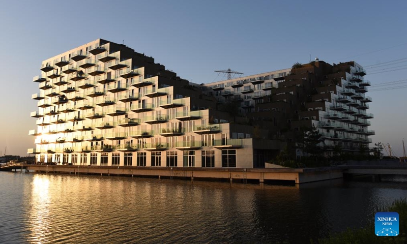 This photo taken on May 26, 2026 shows a view of Sluishuis in Amsterdam, the Netherlands. Sluishuis is a landmark residential building in Amsterdam. Completed in 2022, the building is known for its unique geometric design, with one corner rising upward to create a large opening over the water. (Photo: Xinhua)