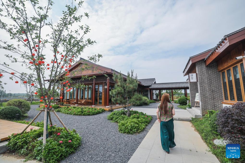A tourist takes a walk at a tea culture experience space in Huanlou Village, Huzhou City, east China's Zhejiang Province, May 27, 2026. Taking the youth entrepreneurship platform as a core link, Huanlou Village has developed a variety of cultural and tourism scenarios including tea culture experience spaces, outdoor camps, local specialty catering outlets, and parent-child interaction programs in recent years. (Photo: Xinhua)