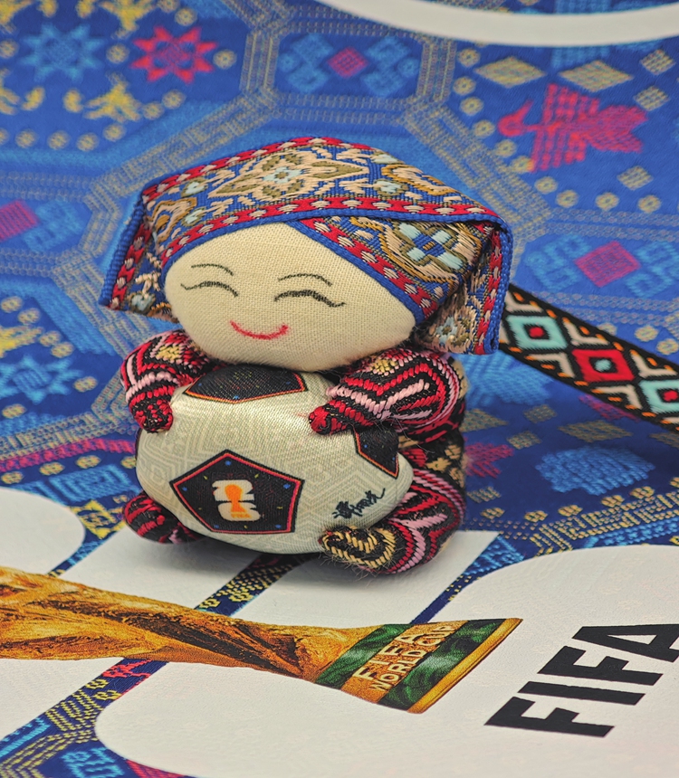 A World Cup licensed product inspired by a traditional Zhuang ethnic mascot, designed by Tan Xiangguang 