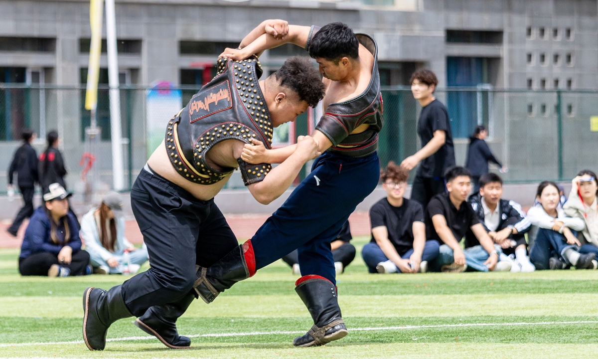 Students from Hohhot Minzu College participate in a Bokh (Mongolian-style wrestling) competition during the campus Naadam Cultural Festival in Hohhot, North China's Inner Mongolia Autonomous Region, on May 27, 2026. The cultural festival featured dragon and lion dances, martial arts performances, ethnic song and dance shows, as well as traditional Naadam sports competitions. Photo: VCG