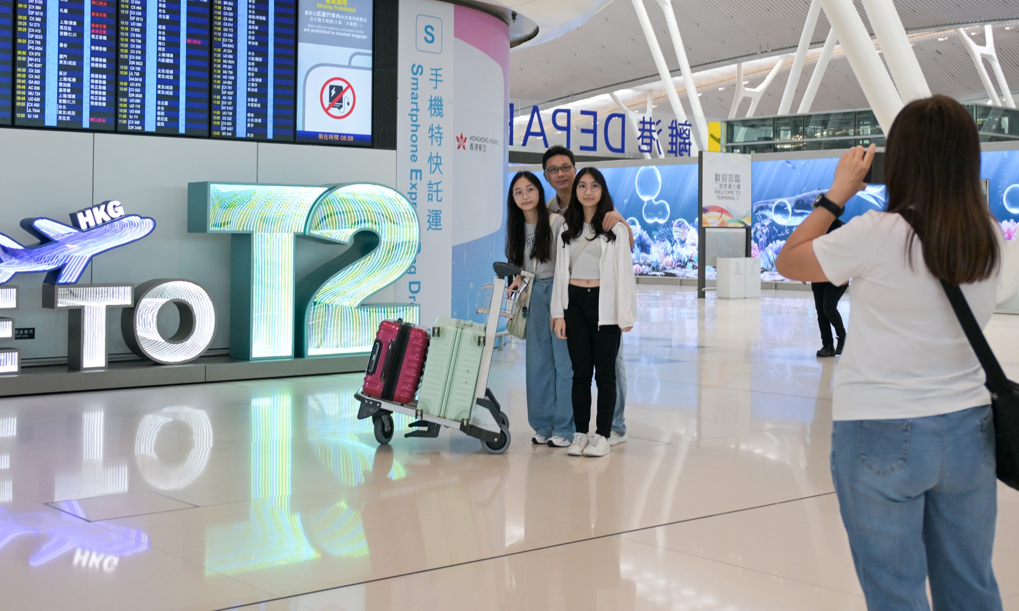 Passengers take photos inside Hong Kong International Airport's Terminal 2 on May 27, 2026, which officially commenced operations on that day. Once fully operational, Terminal 2 is expected to handle up to 30 million passenger trips annually. Photo: VCG