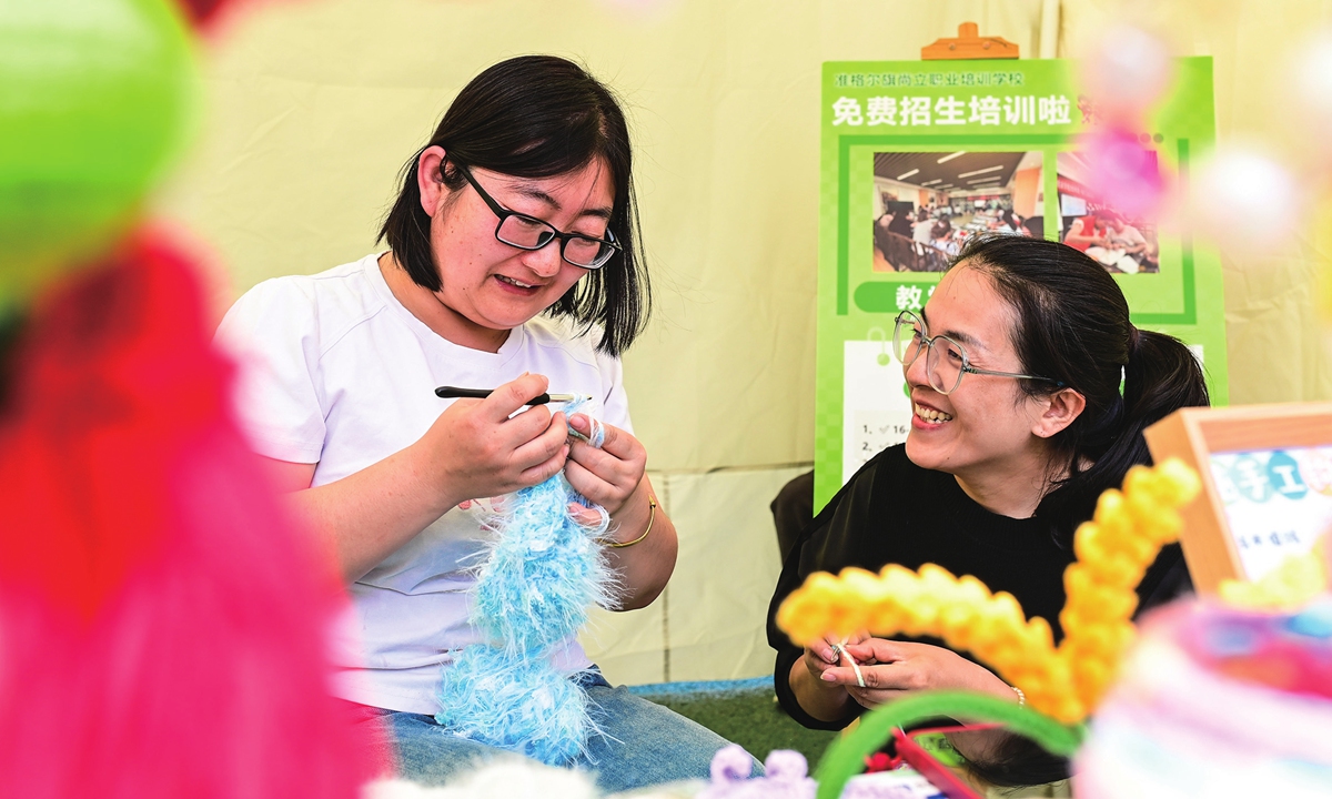 Tourists try handmade wool crochet on a culture street in Ordos, North China's Inner Mongolia Autonomous Region, on May 1, 2026. Photo: VCG