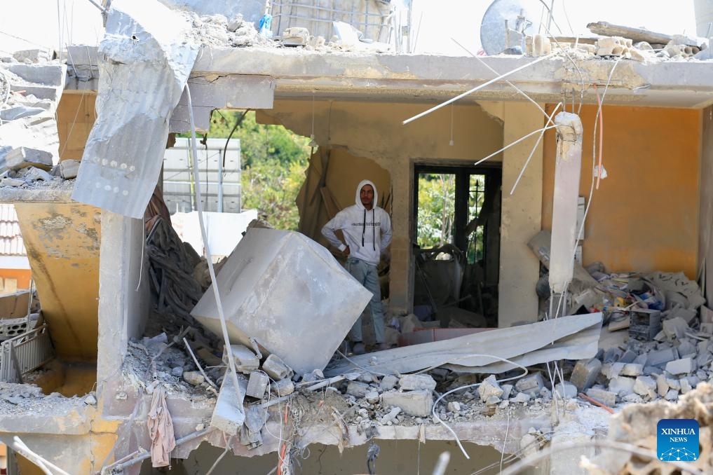 A man inspects a building destroyed by Israeli airstrikes in Borj El Chmali, southern Lebanon, on May 27, 2026. At least 17 people were killed and dozens wounded in Israeli strikes across southern and eastern Lebanon, Lebanese media and health authorities reported Thursday. (Photo by Ali Hashisho/Xinhua)