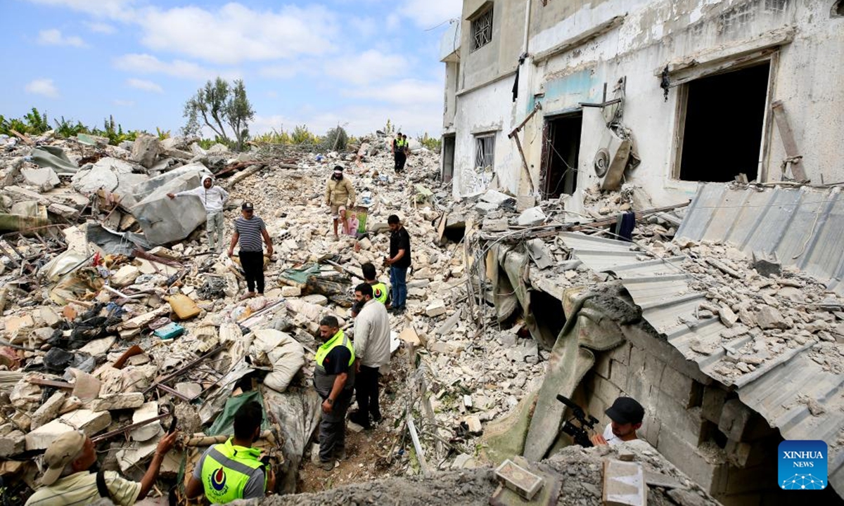 Local people and paramedics inspect the debris of a building destroyed by Israeli airstrikes in Borj El Chmali, southern Lebanon, on May 27, 2026. At least 17 people were killed and dozens wounded in Israeli strikes across southern and eastern Lebanon, Lebanese media and health authorities reported Thursday. (Photo by Ali Hashisho/Xinhua)