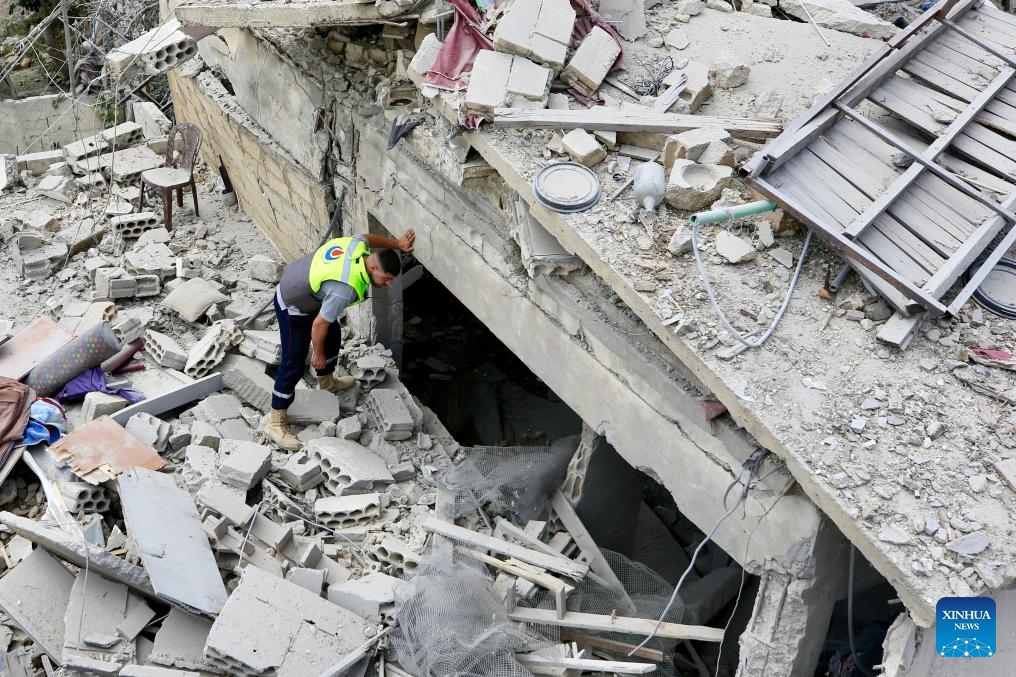 A rescuer works at a building destroyed by Israeli airstrikes in Borj El Chmali, southern Lebanon, on May 27, 2026. At least 17 people were killed and dozens wounded in Israeli strikes across southern and eastern Lebanon, Lebanese media and health authorities reported Thursday. (Photo by Ali Hashisho/Xinhua)