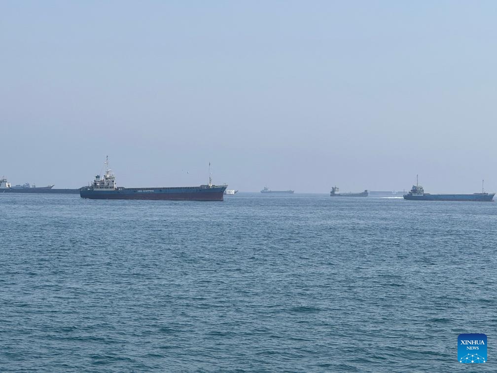 This photo taken with a mobile phone shows merchant vessels stranded in the waters of the Strait of Hormuz, near Khasab, a small town in northern Oman, May 29, 2026. (Photo: Xinhua)