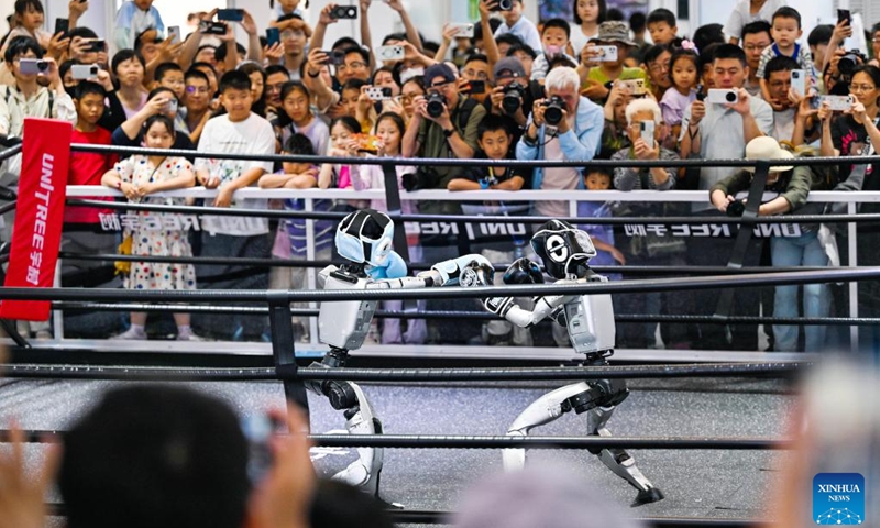 Visitors watch humanoid robots of Unitree Robotics boxing at the World Intelligence Expo 2026 in Tianjin, north China, May 30, 2026. The World Intelligence Expo 2026 opened to the public here on Saturday. The expo brings together over 700 exhibitors to showcase cutting-edge technologies, products and application scenarios in the field of artificial intelligence (AI). (Photo: Xinhua)