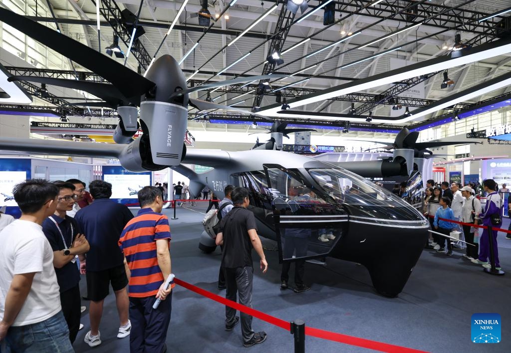 Visitors view a manned aircraft at the World Intelligence Expo 2026 in Tianjin, north China, May 30, 2026. The World Intelligence Expo 2026 opened to the public here on Saturday. The expo brings together over 700 exhibitors to showcase cutting-edge technologies, products and application scenarios in the field of artificial intelligence (AI). (Photo: Xinhua)