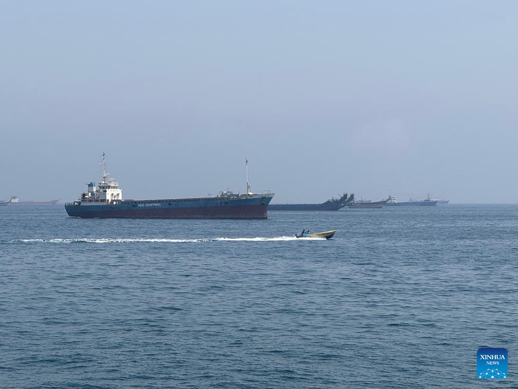 This photo taken with a mobile phone shows merchant vessels stranded in the waters of the Strait of Hormuz, near Khasab, a small town in northern Oman, May 29, 2026. (Photo: Xinhua)