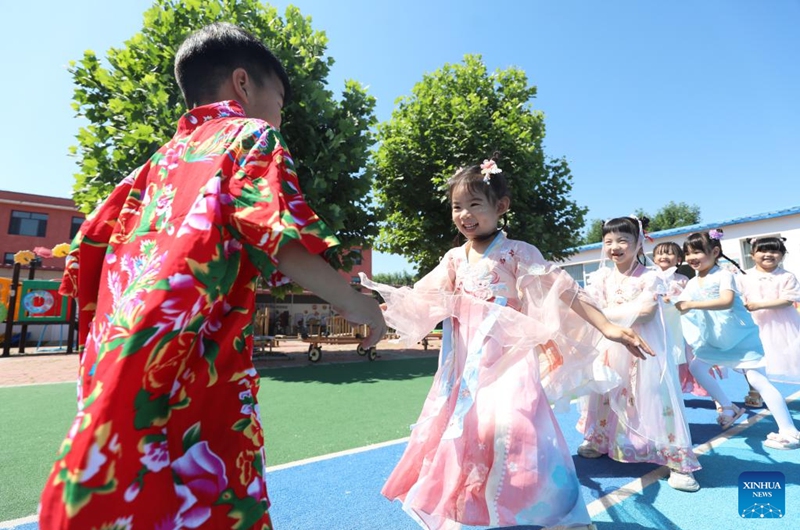 Children play the game of eagle and chicks at a kindergarten in Yangguanlin Town, Tangshan City of north China's Hebei Province, May 30, 2026. Various events are held across the country to celebrate the upcoming International Children's Day. (Photo by Zhu Dayong/Xinhua)