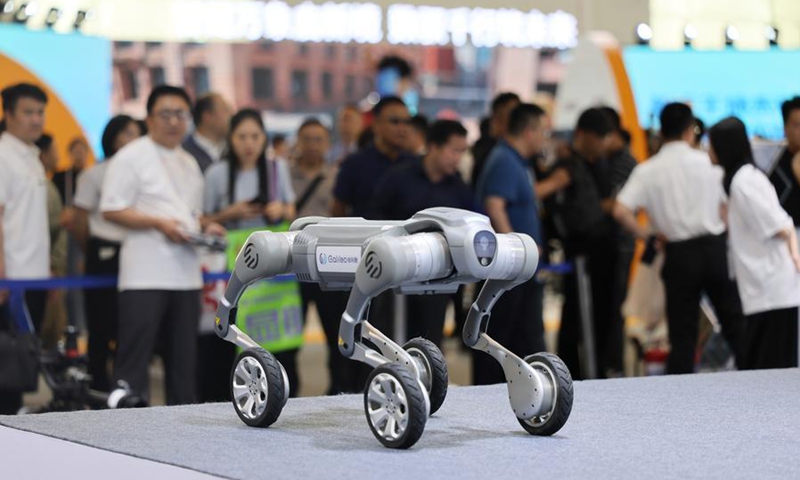 A staff member operates a quadruped robot of Galileo (Tianjin) Technology Co., Ltd. at the World Intelligence Expo 2026 in Tianjin, north China, May 29, 2026. (Xinhua/Li Ran)