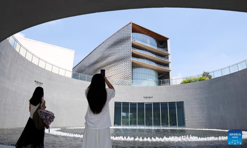 A visitor takes photos outside the Shenzhen International Museum of Art in Shenzhen, south China's Guangdong Province, May 30, 2026. The museum officially opened to the public on Saturday. Photo: Xinhua