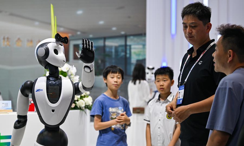 Visitors interact with an embodied AI robot at the World Intelligence Expo 2026 in Tianjin, north China, May 29, 2026. (Xinhua/Zhao Zishuo)