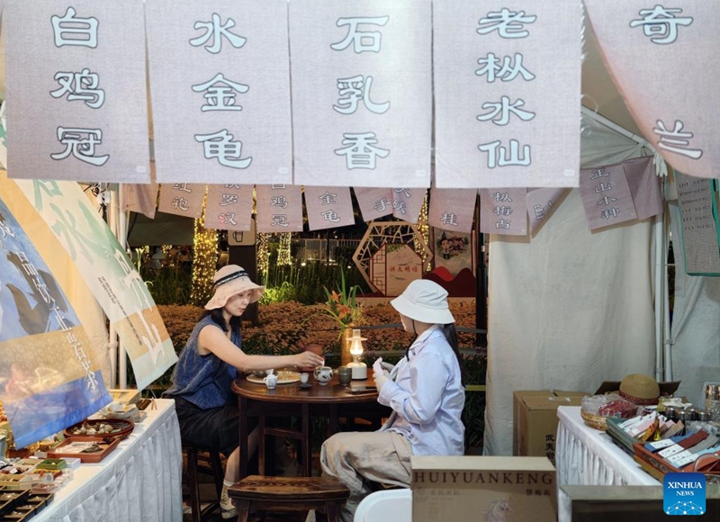 People taste tea during a tea fair in the Financial Street community of Beijing, capital of China, May 30, 2026. The event is held from May 28 to 31 in Xicheng District of Beijing. (Xinhua/Xing Guangli)