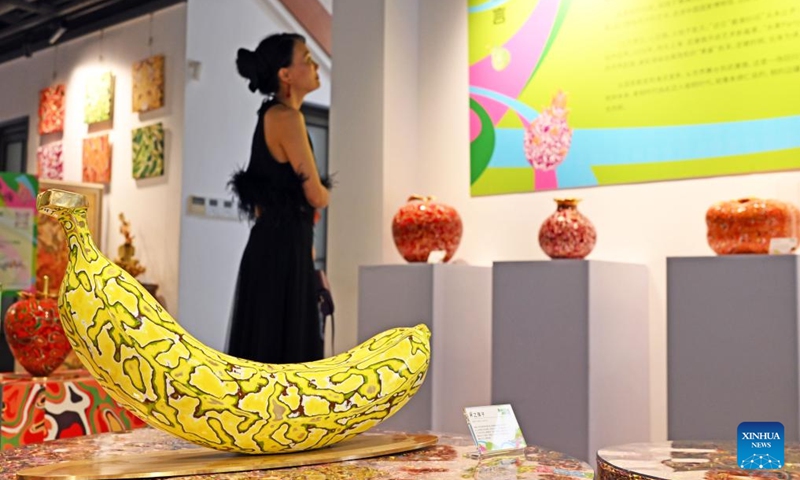 A woman visits a pop-up art show titled Zhu Bingren's fruit party in Shanghai, east China, May 30, 2026. The show will last until June 29. (Xinhua/Liu Ying)