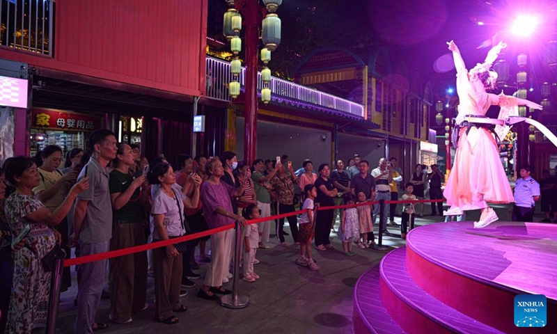 People watch a performance at a tourist attraction in Baoting, south China's Hainan Province, May 29, 2026. Rooted in the distinctive traditions of the Li and Miao ethnic groups, the tourist attraction features immersive night tour experiences as its core draw. (Xinhua/Pu Xiaoxu)