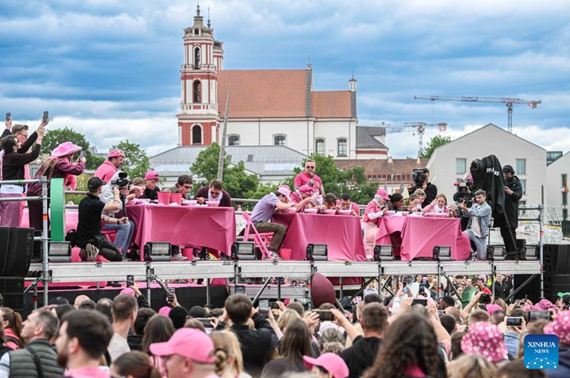 People take part in a saltibarsciai eating contest during the Vilnius Pink Soup Fest in Vilnius, Lithuania, on May 30, 2026. Thousands of residents and tourists joined the annual event here on Saturday celebrating Lithuania's iconic summer dish, saltibarsciai (cold beet soup) with parades, concerts, sports activities, and other cultural events. (Photo by Alfredas Pliadis/Xinhua)