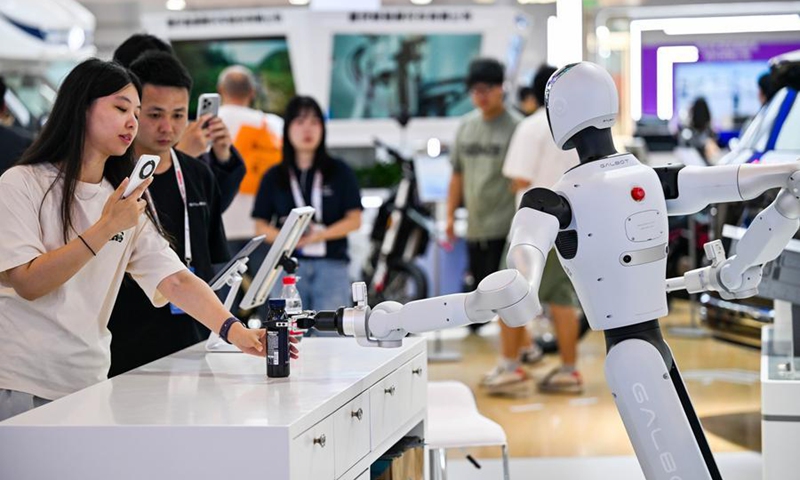 Visitors interact with an embodied AI robot at the World Intelligence Expo 2026 in Tianjin, north China, May 29, 2026. (Xinhua/Zhao Zishuo)