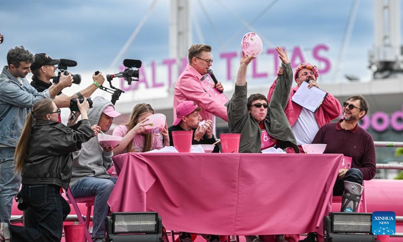 People take part in a saltibarsciai eating contest during the Vilnius Pink Soup Fest in Vilnius, Lithuania, on May 30, 2026. Thousands of residents and tourists joined the annual event here on Saturday celebrating Lithuania's iconic summer dish, saltibarsciai (cold beet soup) with parades, concerts, sports activities, and other cultural events. (Photo by Alfredas Pliadis/Xinhua)