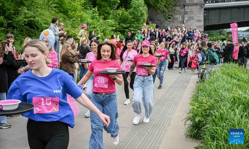 People take part in a soup-carrying race during the Vilnius Pink Soup Fest in Vilnius, Lithuania, on May 30, 2026. Thousands of residents and tourists joined the annual event here on Saturday celebrating Lithuania's iconic summer dish, saltibarsciai (cold beet soup) with parades, concerts, sports activities, and other cultural events. (Photo by Alfredas Pliadis/Xinhua)