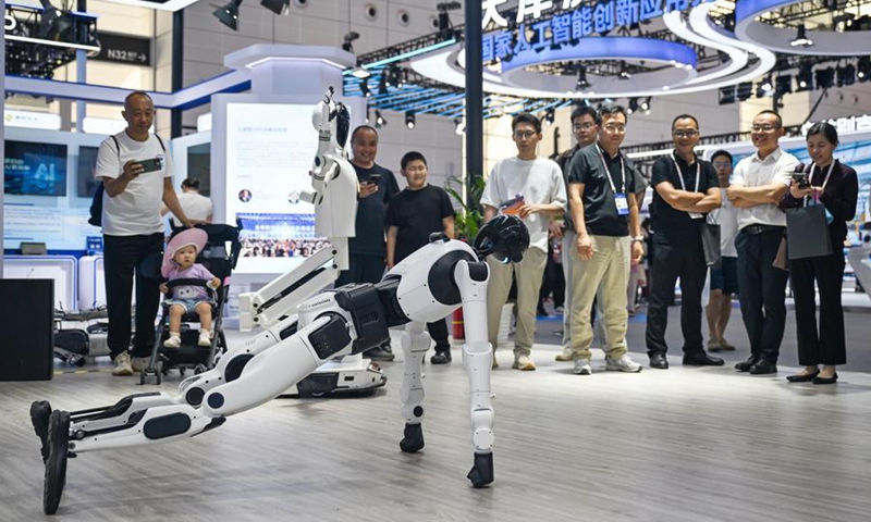 People watch an embodied AI robot doing push-ups at the World Intelligence Expo 2026 in Tianjin, north China, May 29, 2026. (Xinhua/Zhao Zishuo)