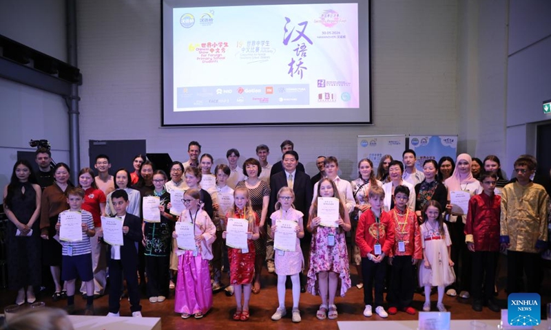Participants pose for a group photo after the 19th Chinese Bridge Chinese Proficiency Competition for secondary school students and the 6th Chinese Bridge Show for primary school students in Hannover, Germany, on May 30, 2026. The German finals of the 19th Chinese Bridge Chinese Proficiency Competition for secondary school students and the 6th Chinese Bridge Show for primary school students were held here on Saturday. (Xinhua/Du Zheyu)