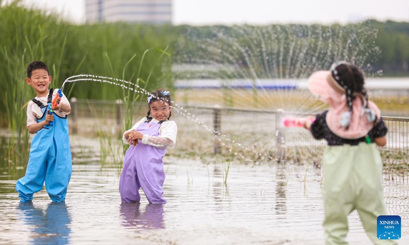 Children play at an artificial sandy beach in Hai'an City, east China's Jiangsu Province, May 30, 2026. Various events are held across the country to celebrate the upcoming International Children's Day. (Photo by Gu Binbin/Xinhua)