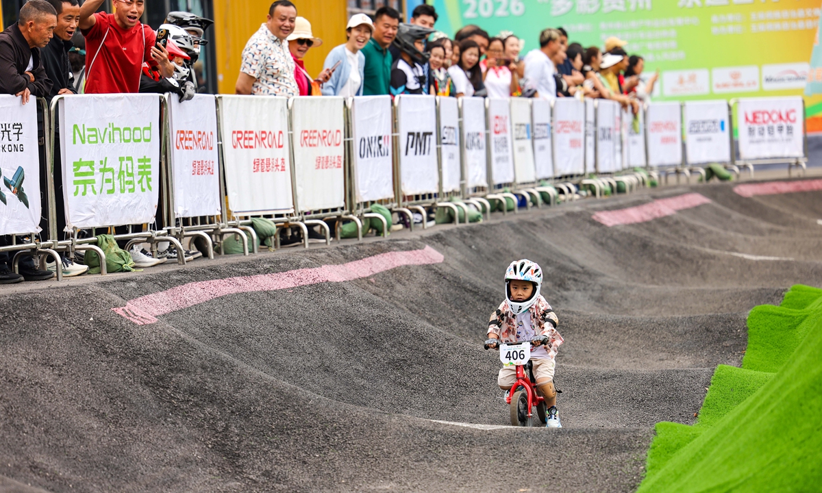 A child rides in a pump track cycling competition in the Yuping Dong autonomous county, Southwest China's Guizhou Province, on May 31, 2026. A pump track features undulating trails and banked berms, suitable for a wide range of wheeled sports such as inline skating, skateboarding, BMX, balance bikes and mountain biking. Photo: VCG