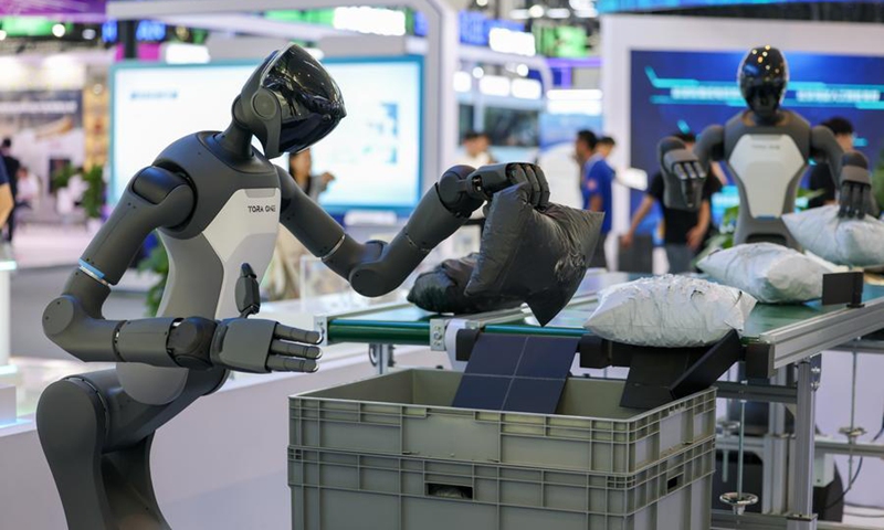 A humanoid robot of PaXini, a haptic technology and humanoid robotics company, demonstrates its package gripping ability at the World Intelligence Expo 2026 in Tianjin, north China, May 28, 2026.  (Xinhua/Sun Fanyue)