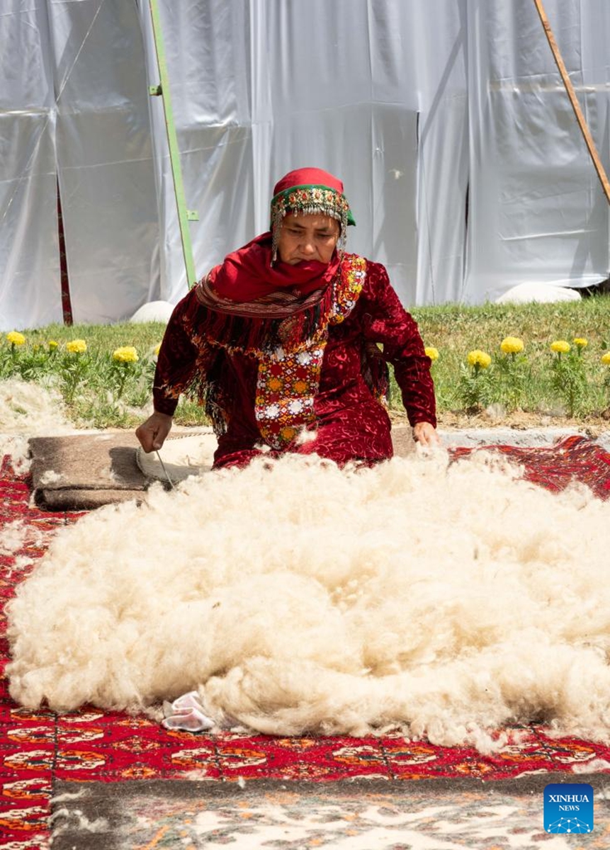A woman demonstrates carpet-making during a Turkmen Carpet Day celebration in Ashgabat, Turkmenistan, May 31, 2026. (Photo by Cui Jiaxin/Xinhua)