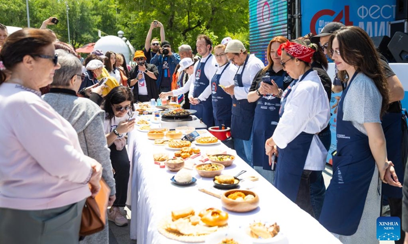 People participate in a pollack festival in Vladivostok, Russia, on May 30, 2026. Pollack is a popular seafood ingredient among the locals here. (Photo by Andrey Matveenko/Xinhua)
